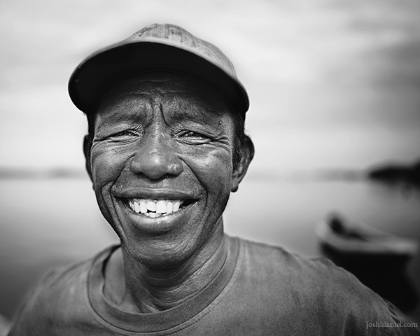 28mm black and white portrait of a smiling fisherman from Debut Port, Kei Island (Kai Island), Maluku, Indonesia