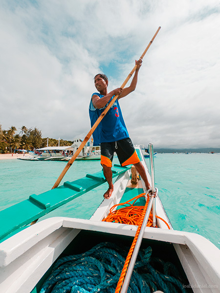 Portrait of a man rowing a boat in White Beach, Boracay, Philippines