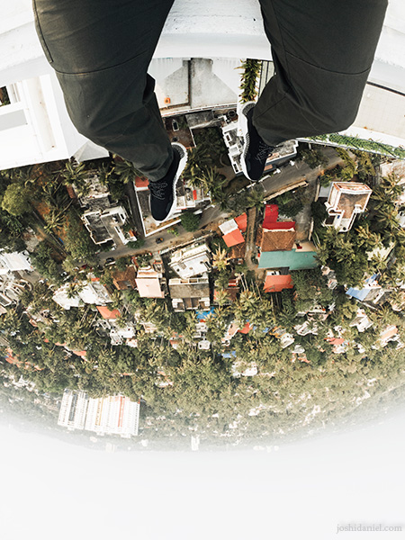 GoPro shot of joshi daniel's feet dangling above the cityscape of Trivandrum, Kerala, India