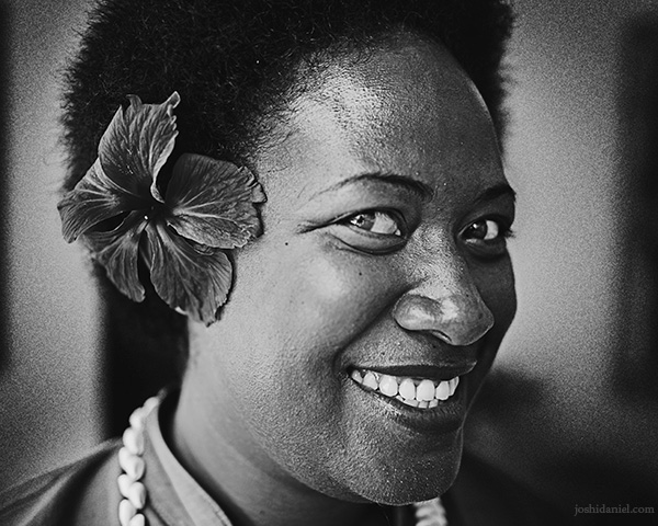 A 28mm wide angle black and white portrait of a smiling Fijian lady from Paradise Cove Resort, Naukacuvu Island, Fiji
