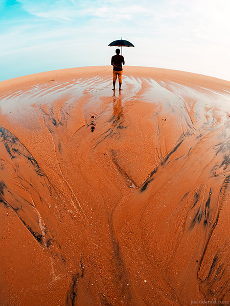 A GoPro photo of Chandrakanth C K holding an umbrella and standing at the seashore in Trivandrum, Kerala, India