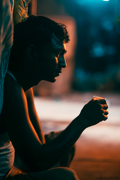 Portrait of a washerman sitting with a glass of tea in his hand in Dhobi Ghat, Mumbai, Maharashtra, India