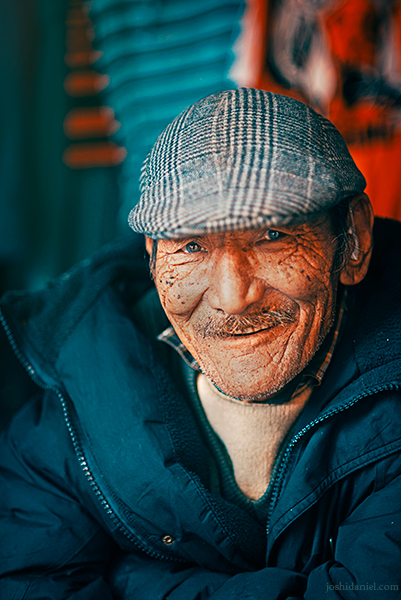 Portrait of a smiling roadside shopkeeper in Mcleod Ganj, Dharamsala, Himachal Pradesh, India
