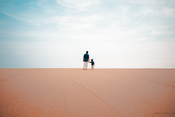 Job Kurian and his son holding hands at a beach in Trivandrum, Kerala, India.
