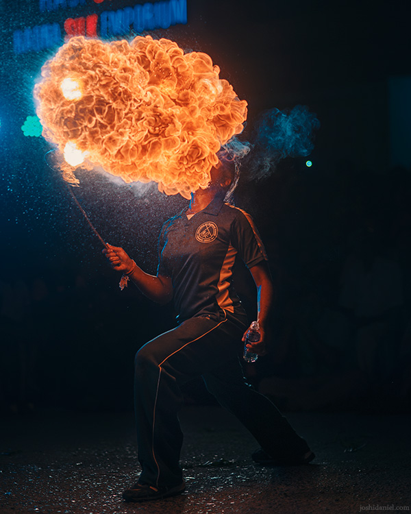 A girl performing a fire eating stunt during the Mylapore, Chennai, Tamil Nadu, India