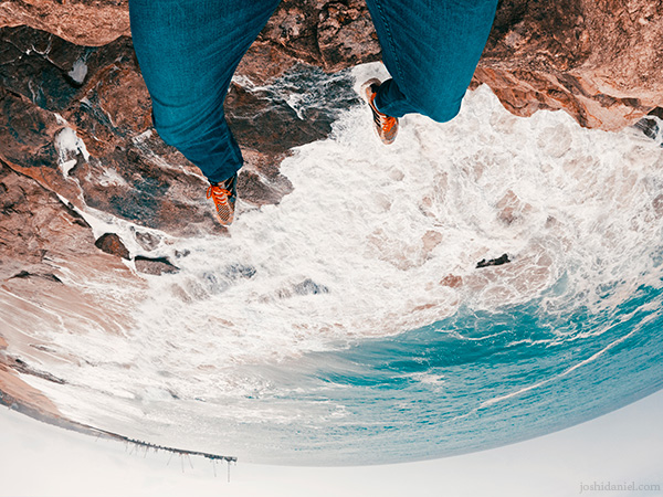 GoPro shot of joshi daniel's feet dangling from the edge of a cliff in Trivandrum, Kerala, India