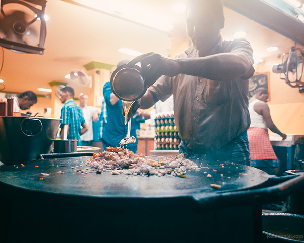 Portrait of a man in the process of making kothu parotta in Madurai, Tamil Nadu, India