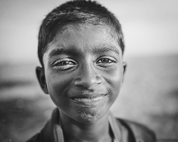 A 28mm wide angle black and white portrait of a smiling boy from Trivandrum, Kerala, India