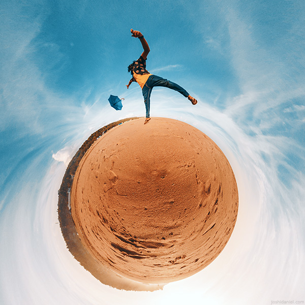 Little planet (tiny planet) photograph of Abilash Thankan jumping with an umbrella on a beach in Trivandrum, Kerala, India